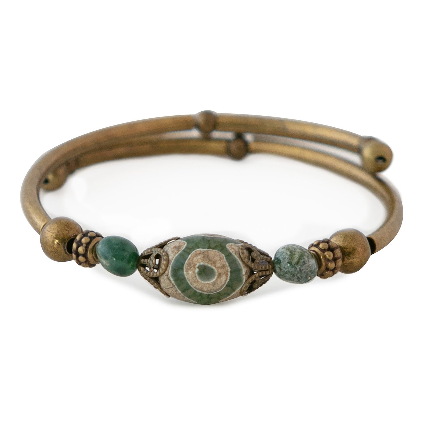 Brass bracelet with green beads on a white background