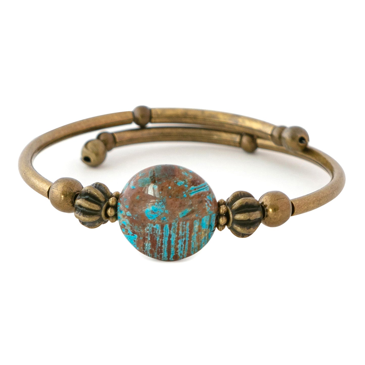 Brass bracelet with a large brown and turquoise bead on a white background