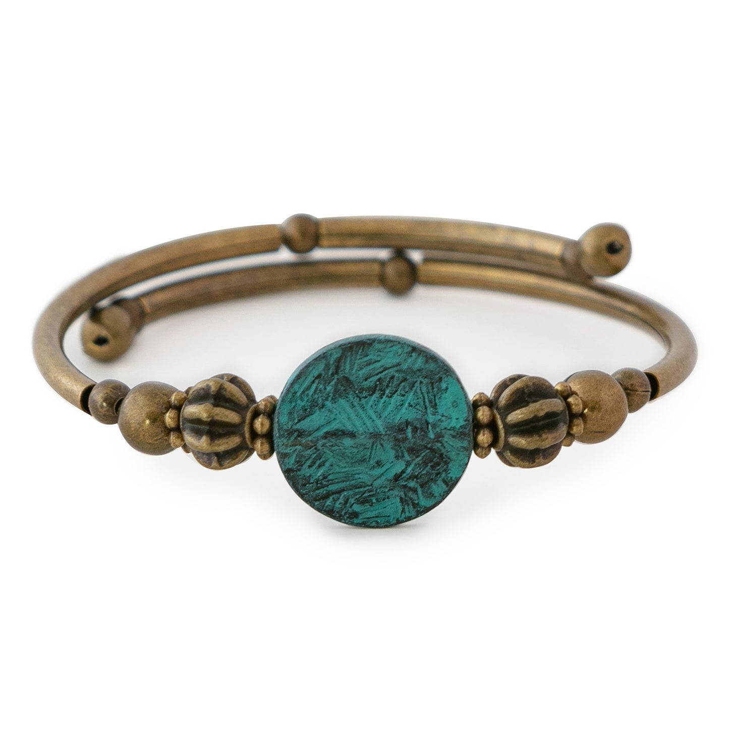 Brass bracelet with a green metal disc on a white background