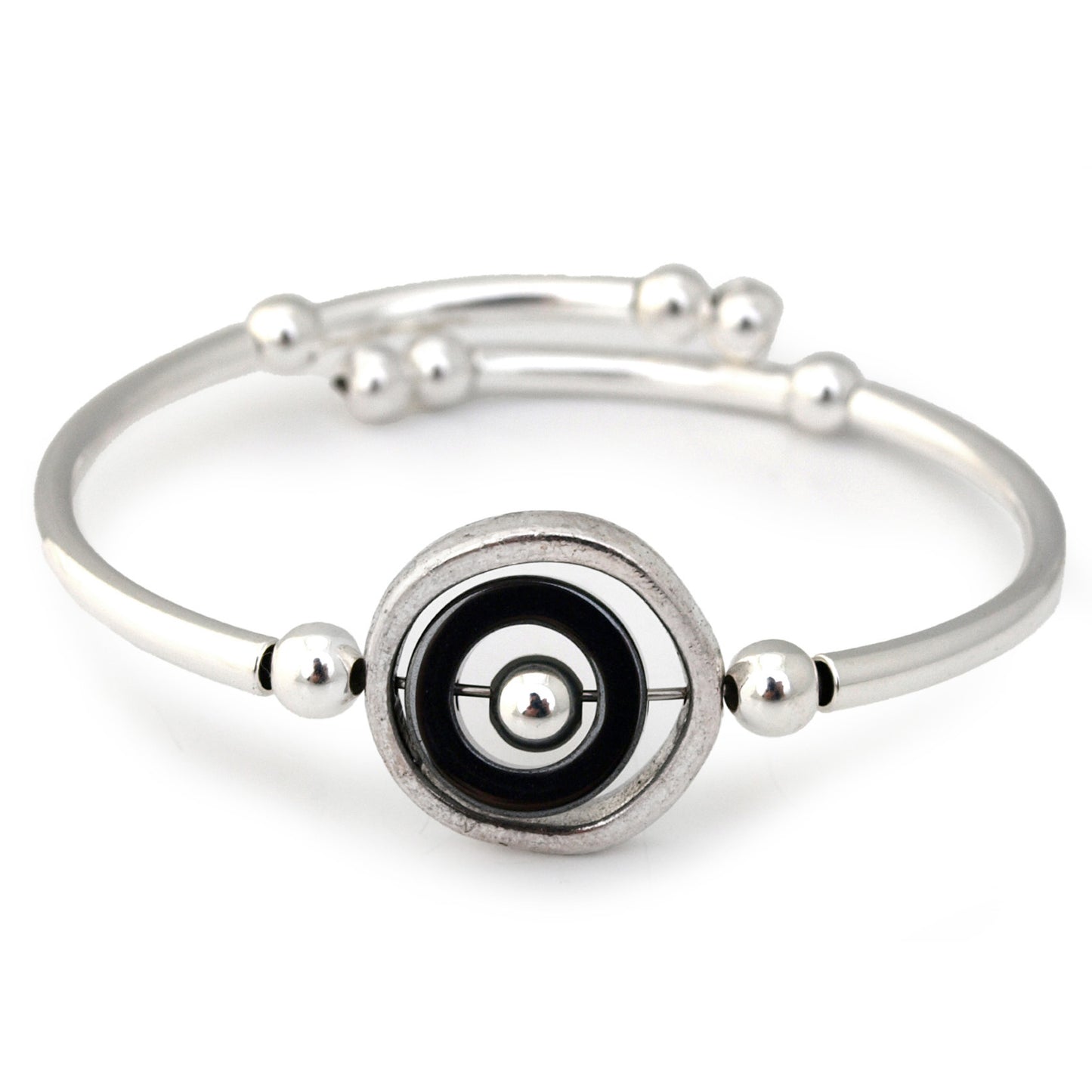 Silver bracelet with a black and silver circular design on a white background