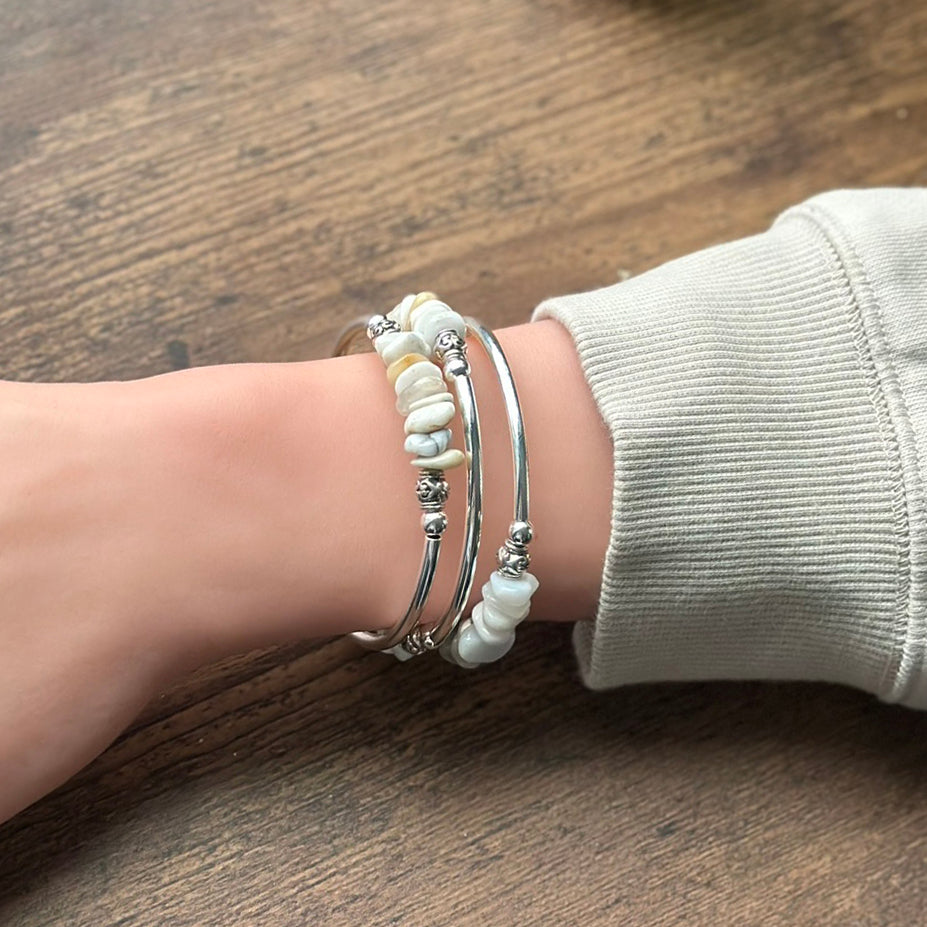 Silver bracelet with white agate nuggets on a wrist
