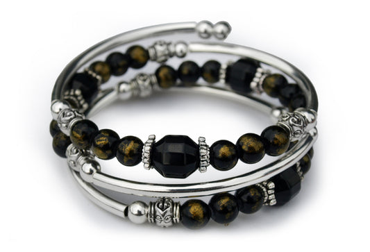 Black and gold beaded bracelet on white background