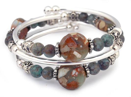 Blue and Brown beads on a silver bracelet on white background
