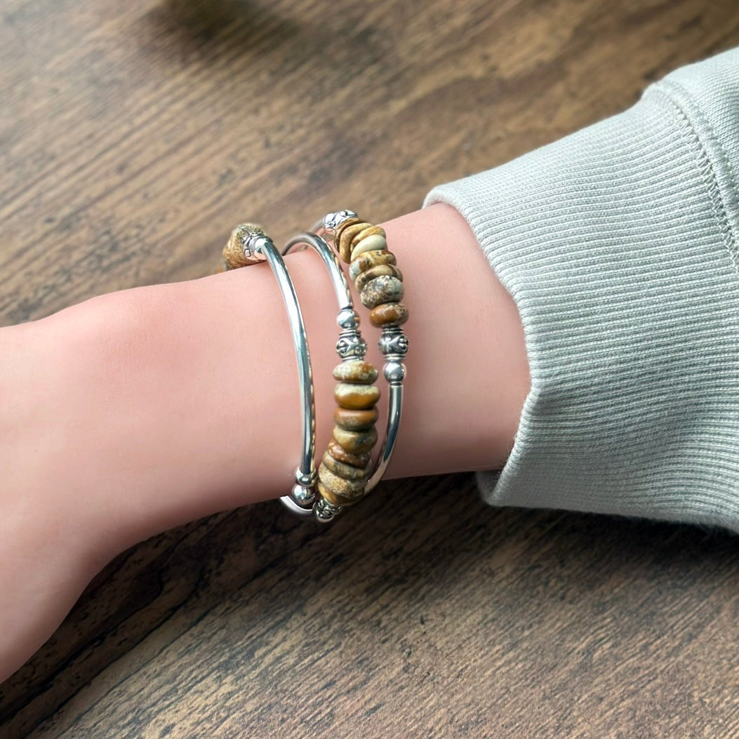 Beaded bracelet on a wrist with a wooden background