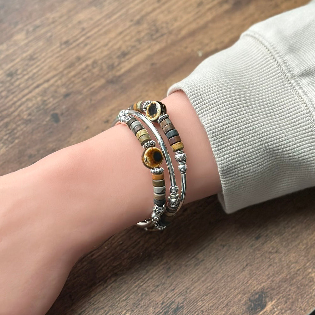 Brown gemstone and silve rbracelet on wrist
