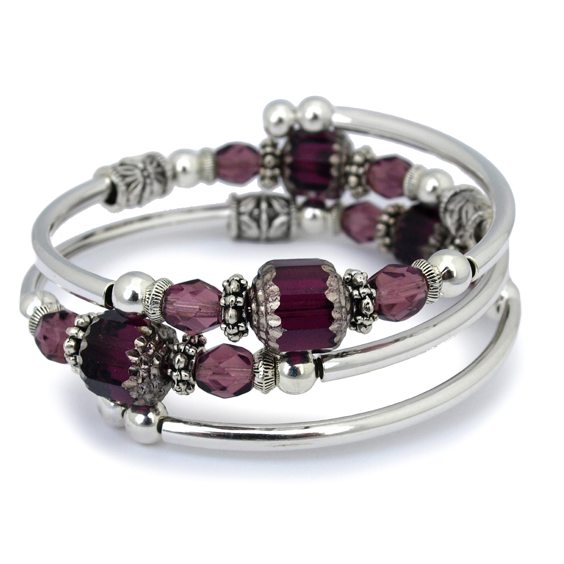Silver bracelet with faceted purple glass beads on a white background