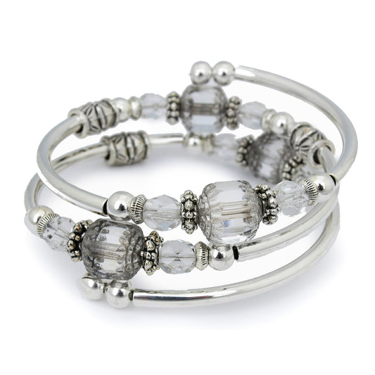 Silver bracelet with clear faceted glass beads on a white background