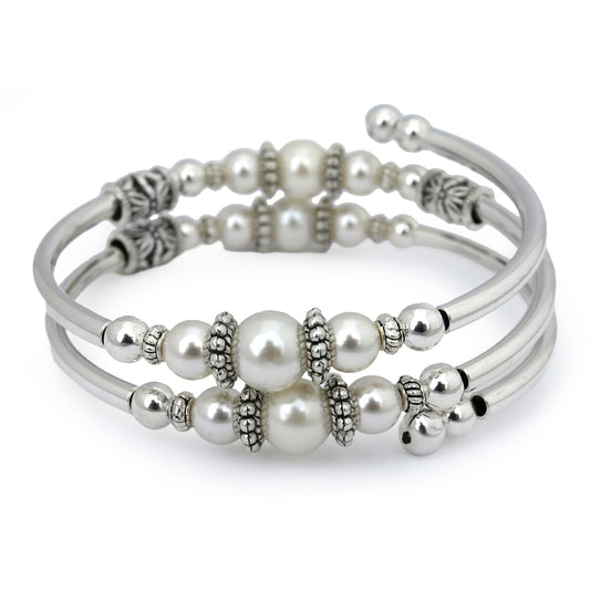 Silver bracelet with white pearls on a white background