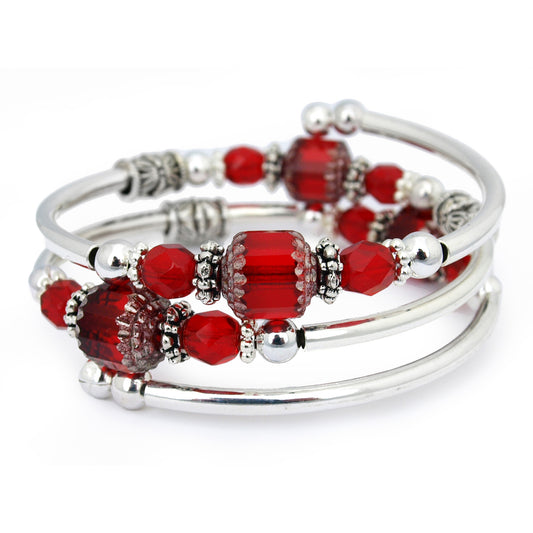 Silver bracelet with red faceted glass beads on a white background