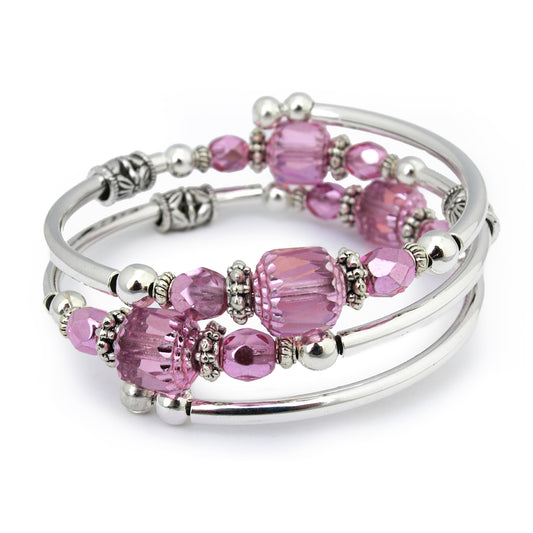 Silver bracelet with pink faceted beads on a white bacground