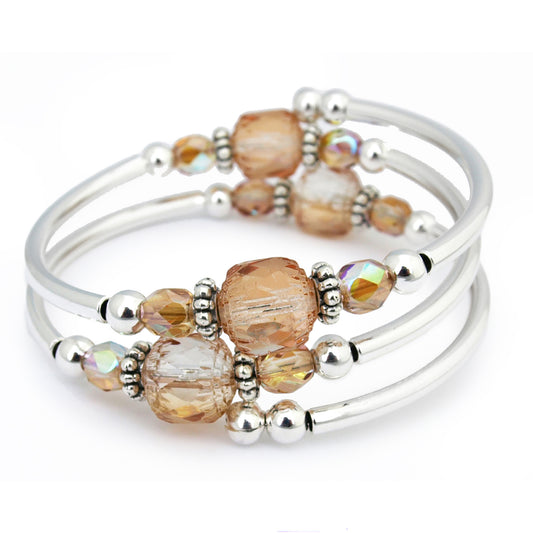 Beaded light brown stones with silver accents on a white background