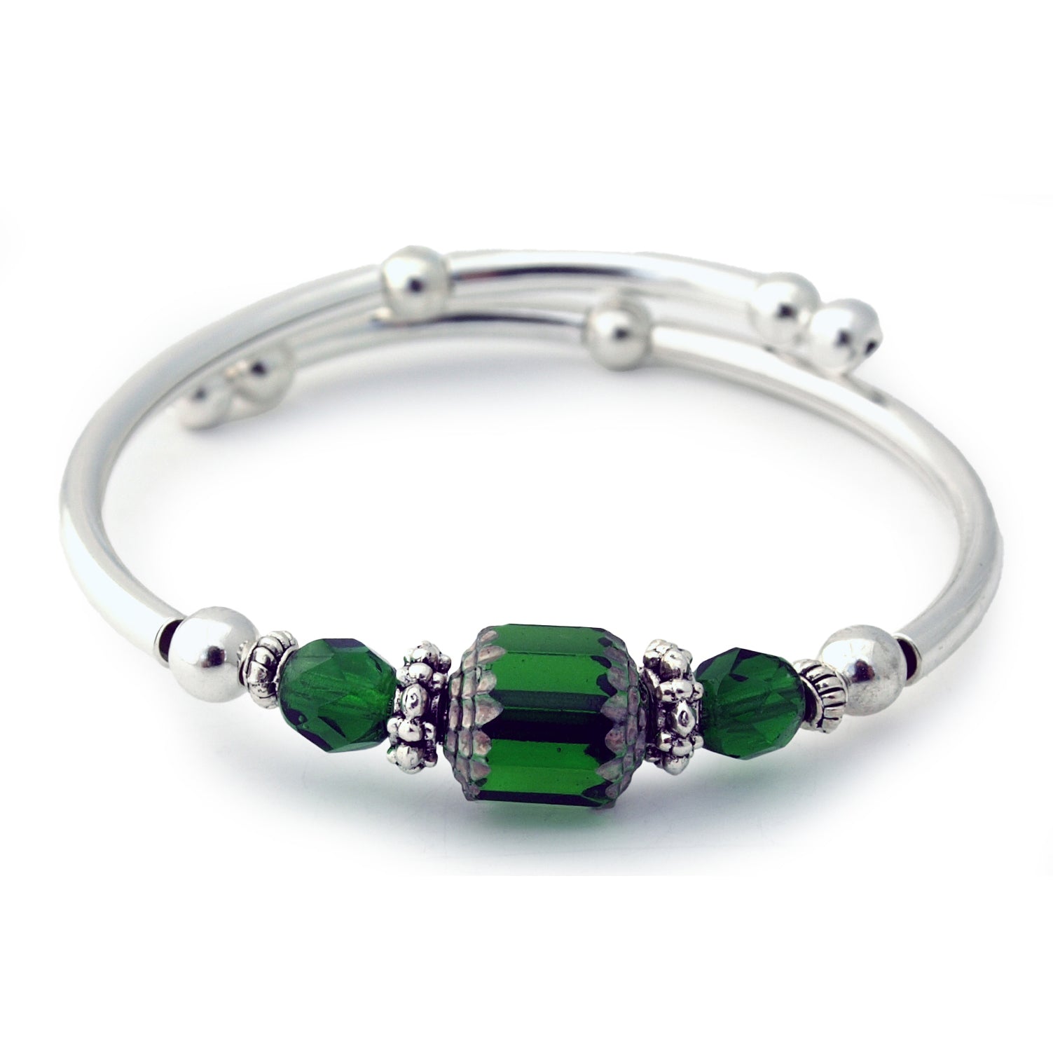 Silver bracelet with green beads on a white background