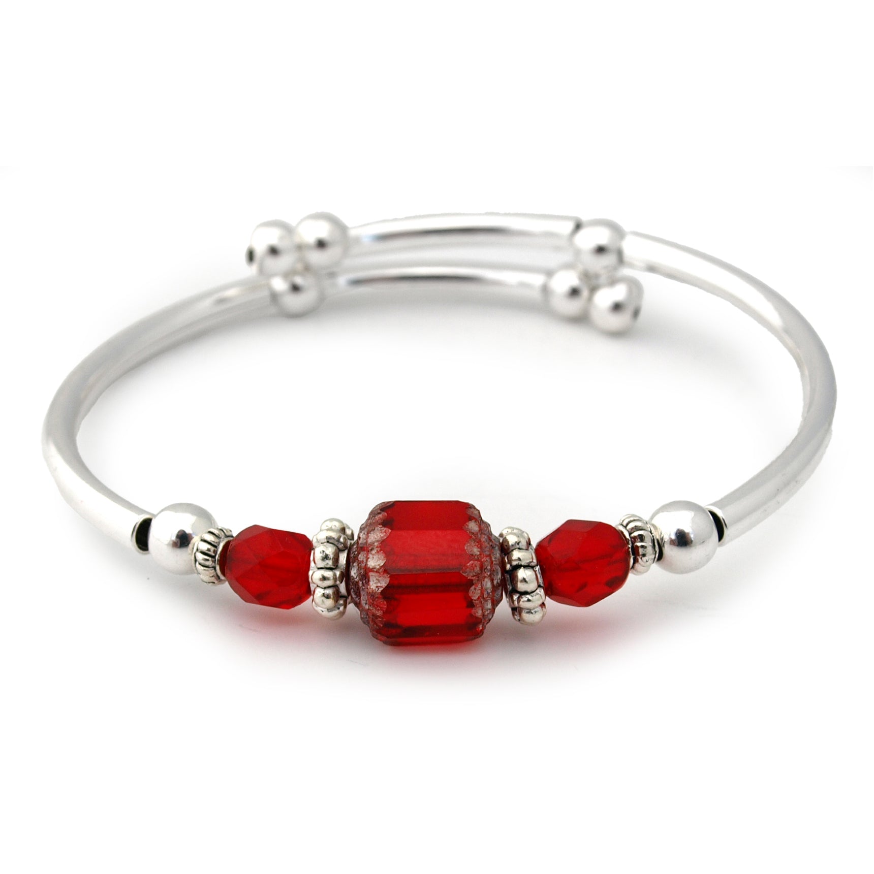 Silver bracelet with red beads on a white background