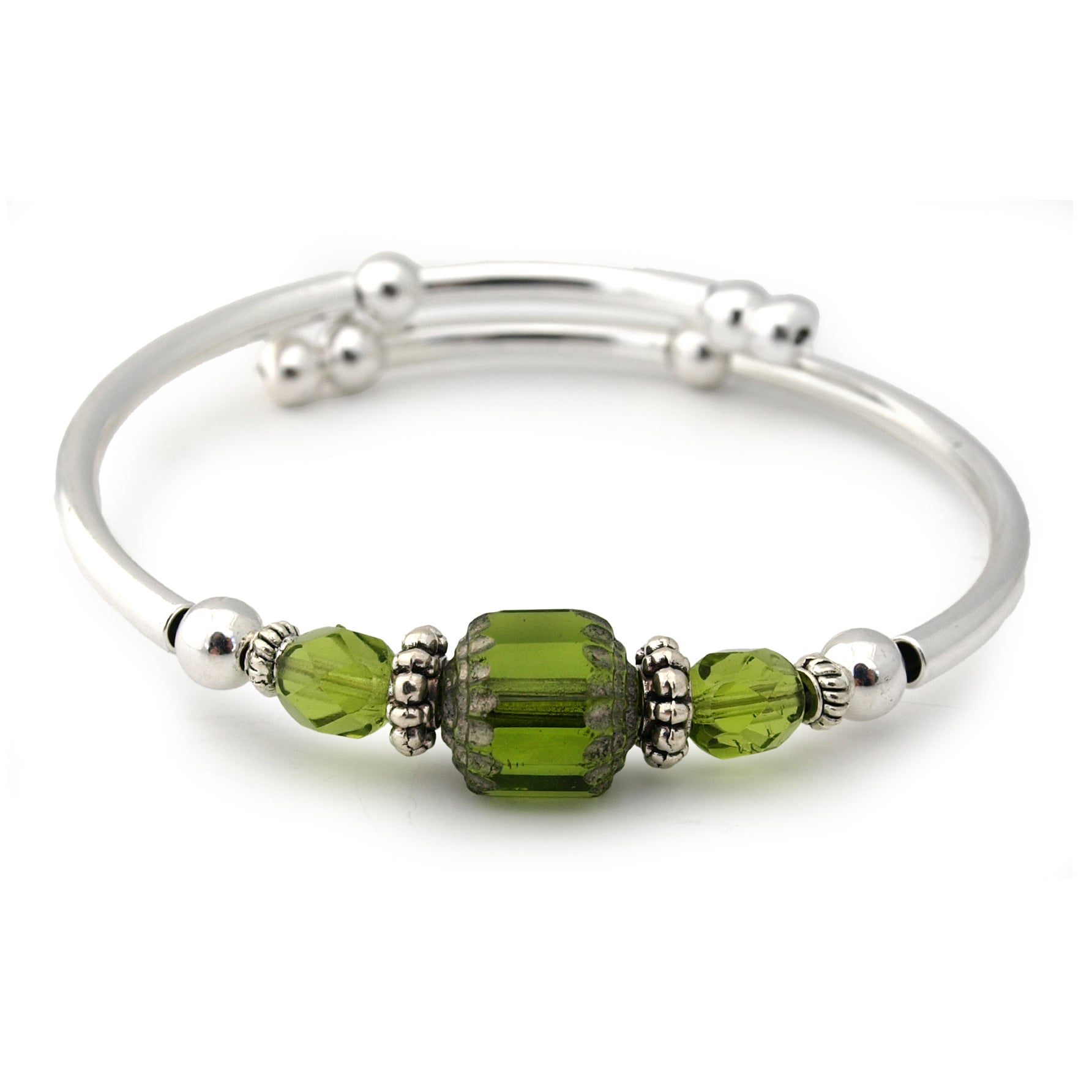 Silver bracelet with green beads on a white background