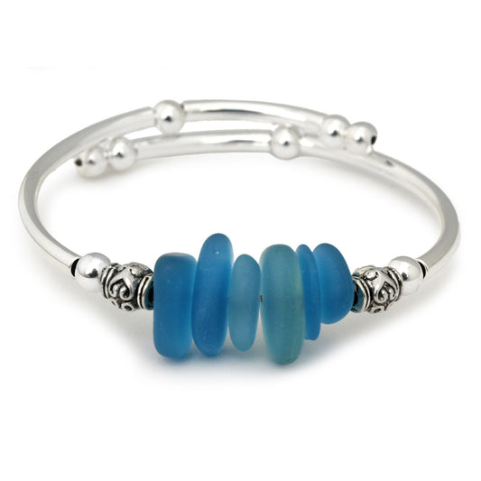 Silver bracelet with blue beads on a white background