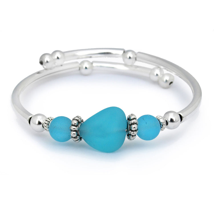 Silver bracelet with turquoise beads on a white background