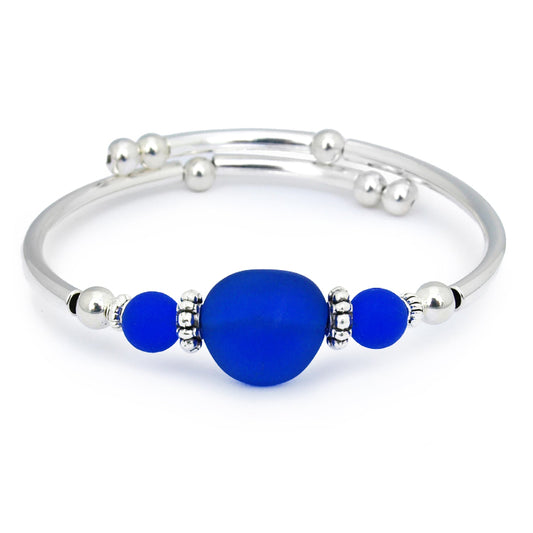 Silver bracelet with blue beads on a white background
