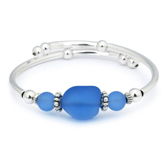 Silver bracelet with blue beads on a white background