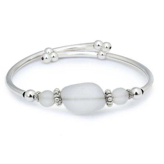 Silver bracelet with white beads on a white background
