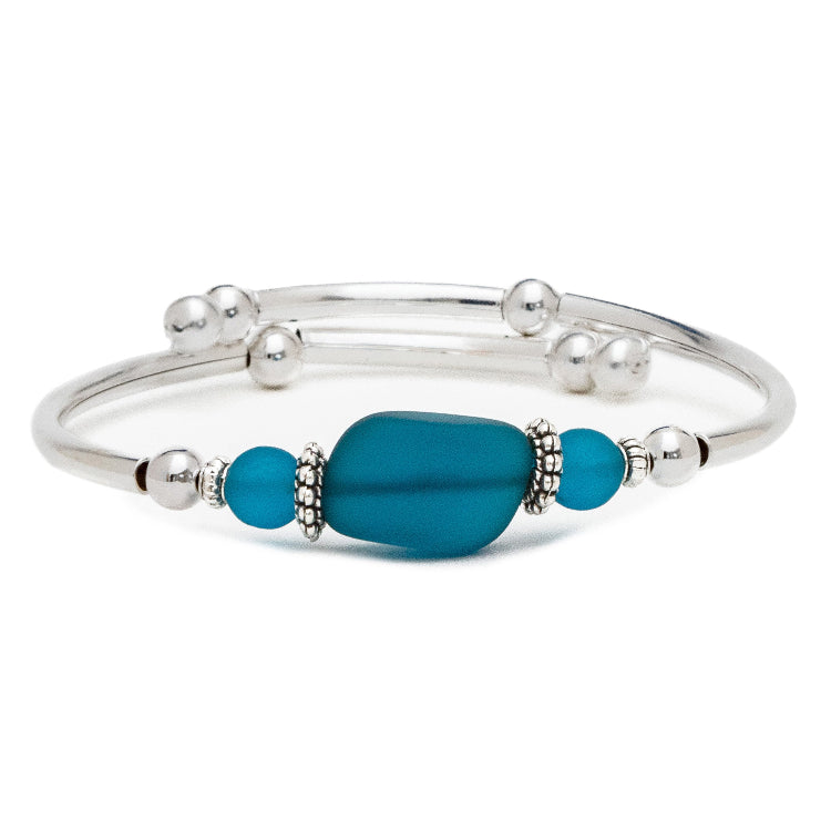 Silver bracelet with blue beads on a white background
