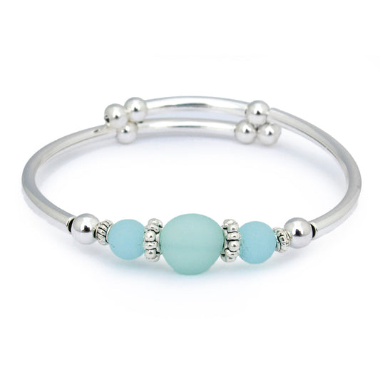 Silver bracelet with turquoise beads on a white background
