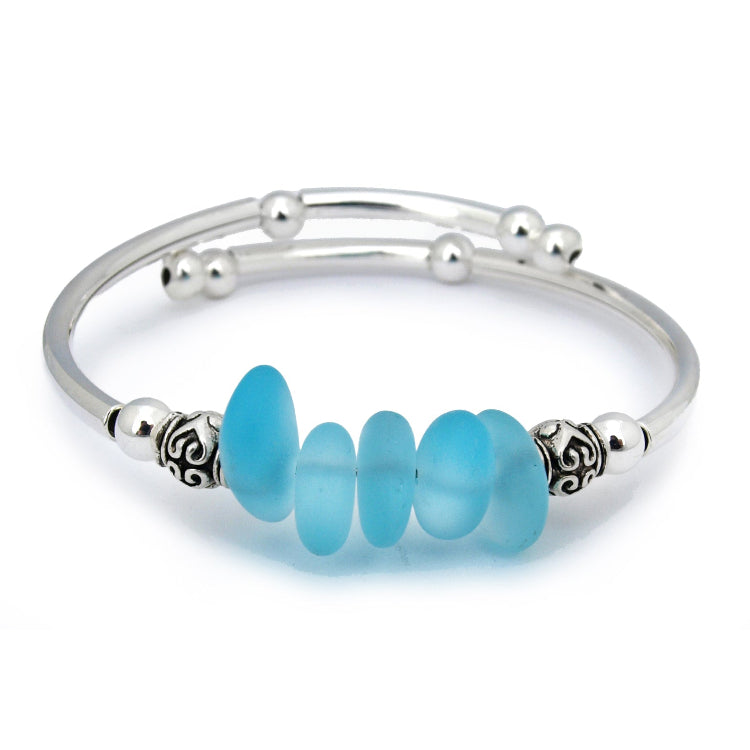 Silver bracelet with blue beads on a white background