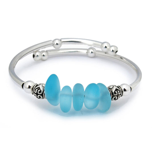 Silver bracelet with blue beads on a white background