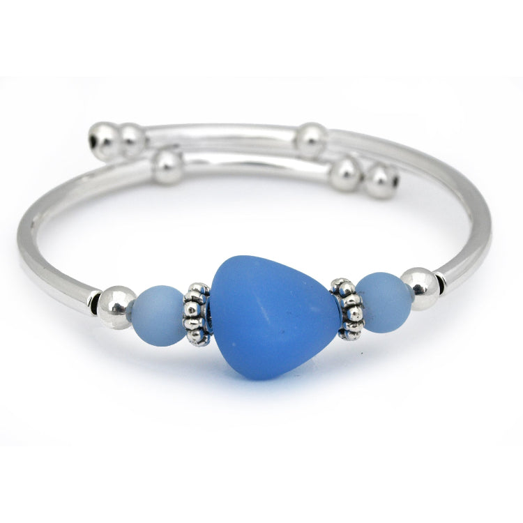 Silver bracelet with blue heart-shaped beads on a white background