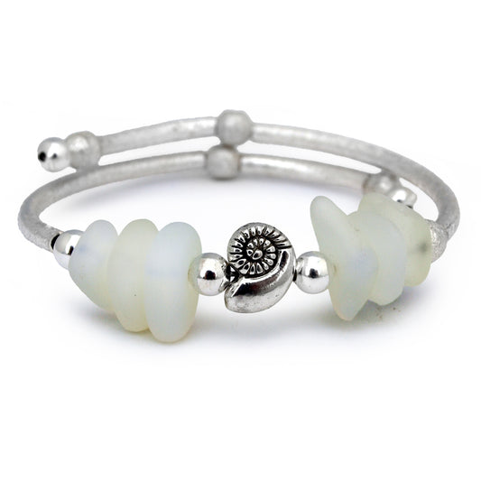 Silver bracelet with opaline sea glass beads and nautilus shell charm on white background