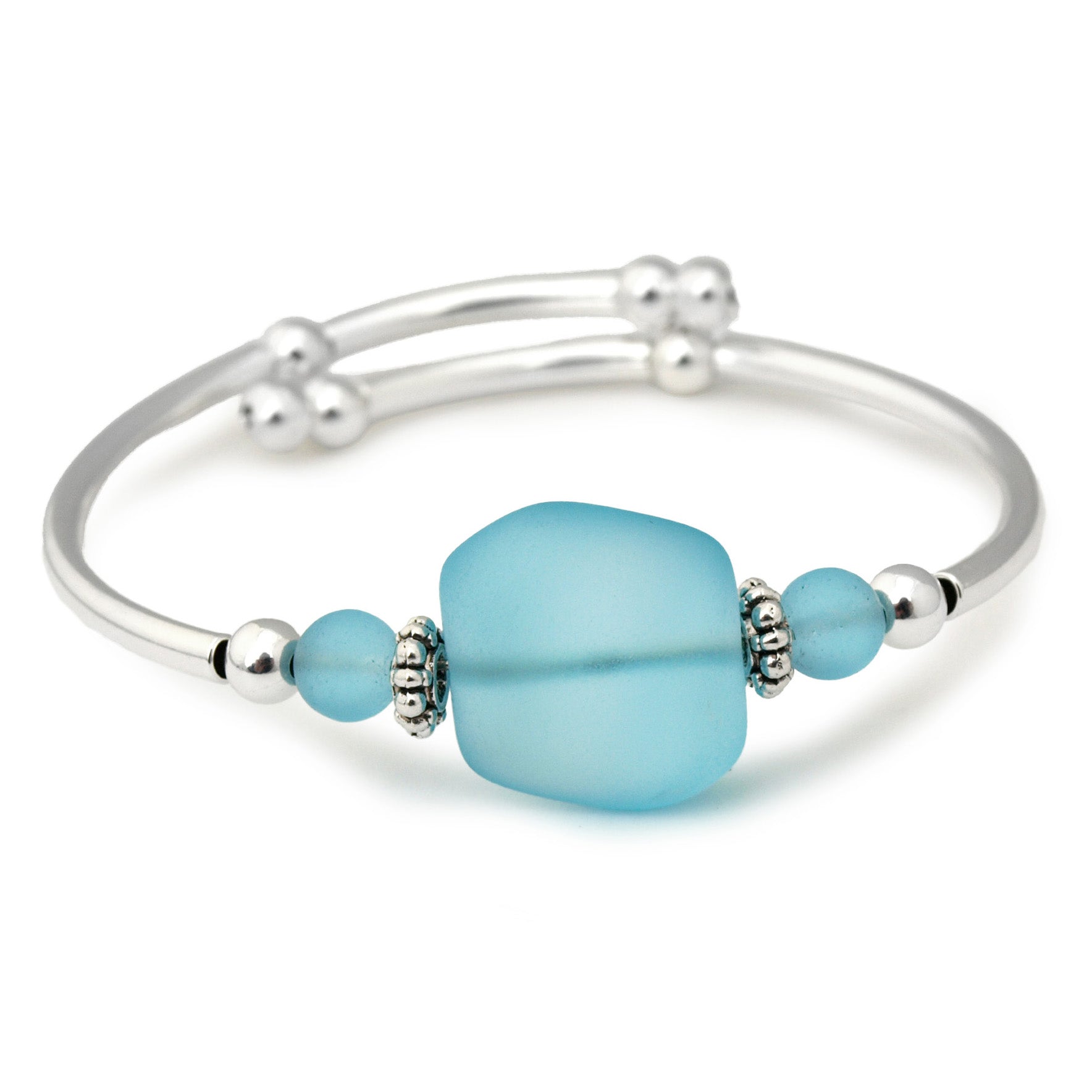 Silver bracelet with frosted aqua blue sea glass bead on a white background