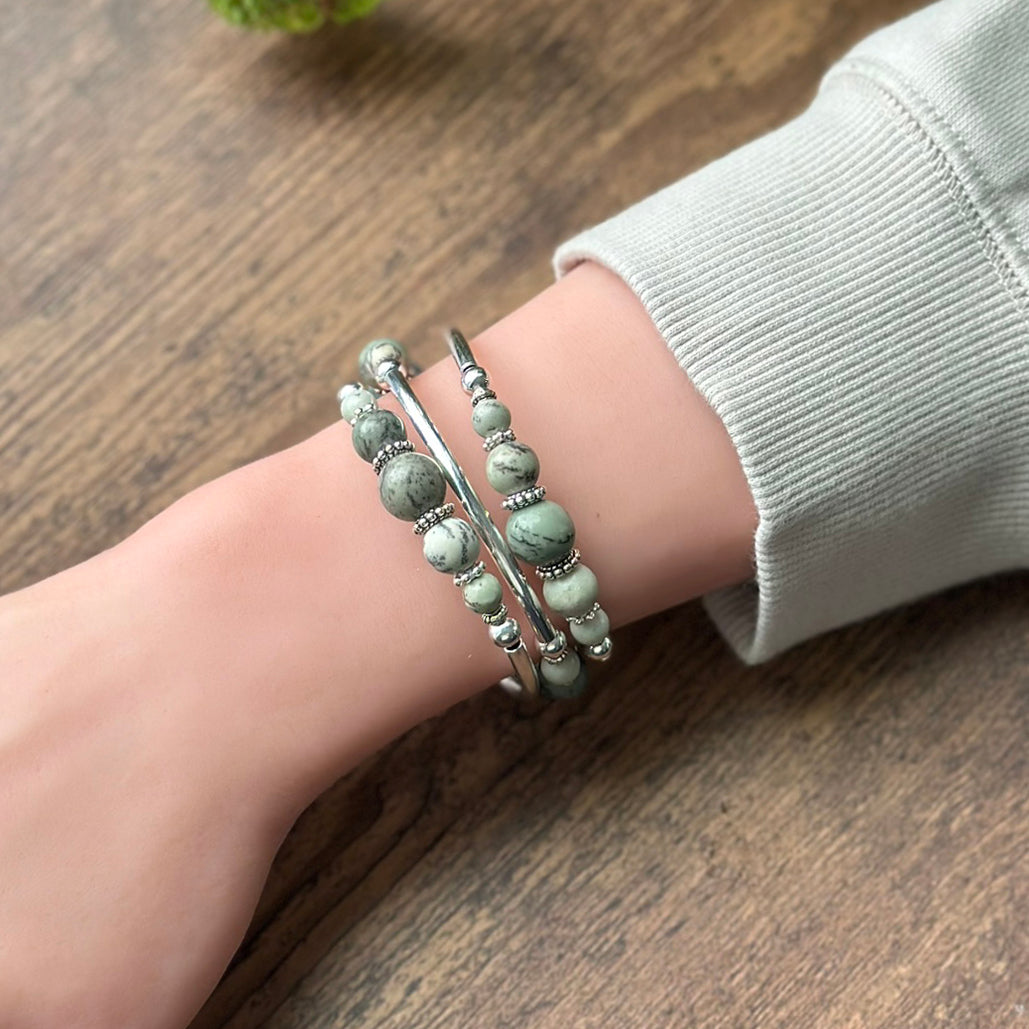 Green stone bracelet with silver on a wrist