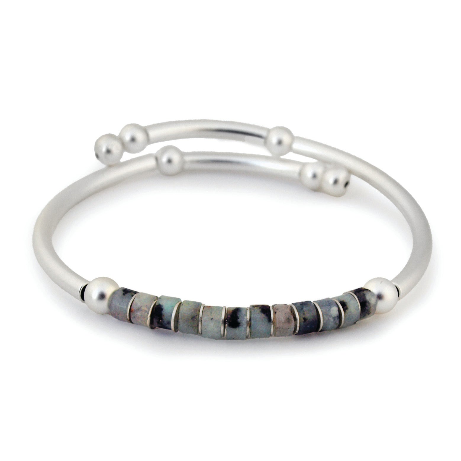 Silver bracelet with embedded stones on a white background