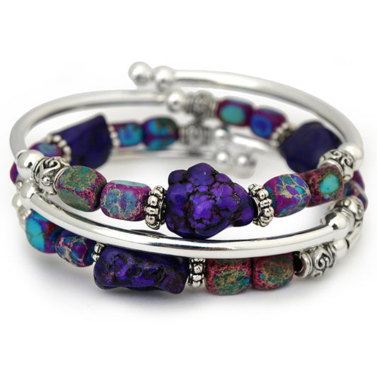 Silver bracelet with purple and blue nuggets on white background