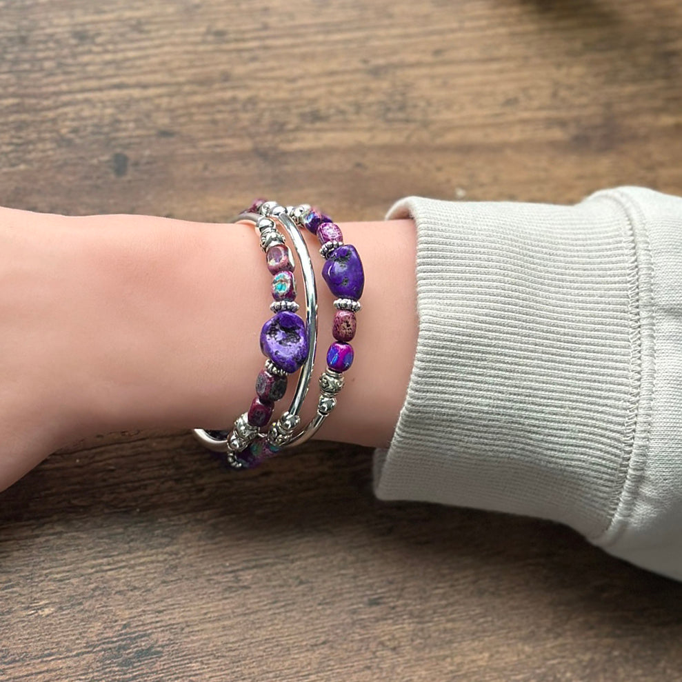 Silver bracelet with purple and blue nuggets on wrist