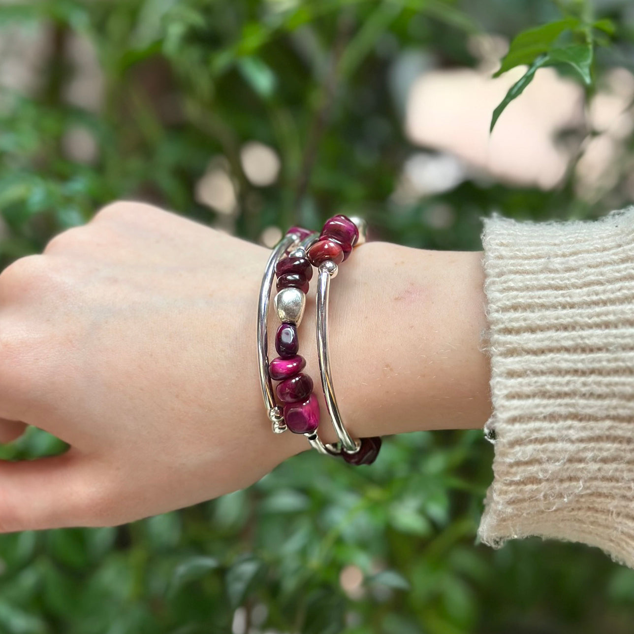 Silver wrap bracelet with magenta and burgundy beads on wrist