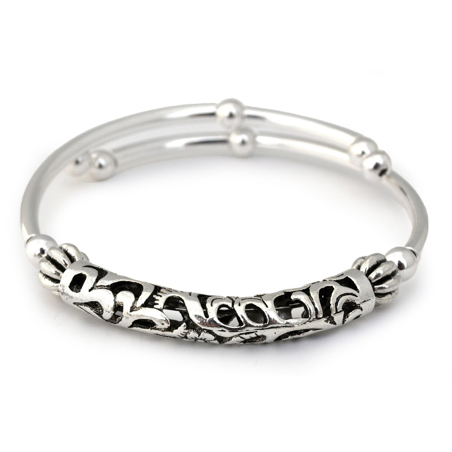 Silver bangle with intricate design on a white background