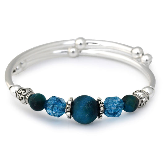 Silver bracelet with blue beads on a white background