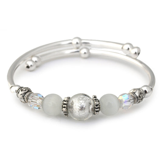 Silver bracelet with beads on a white background