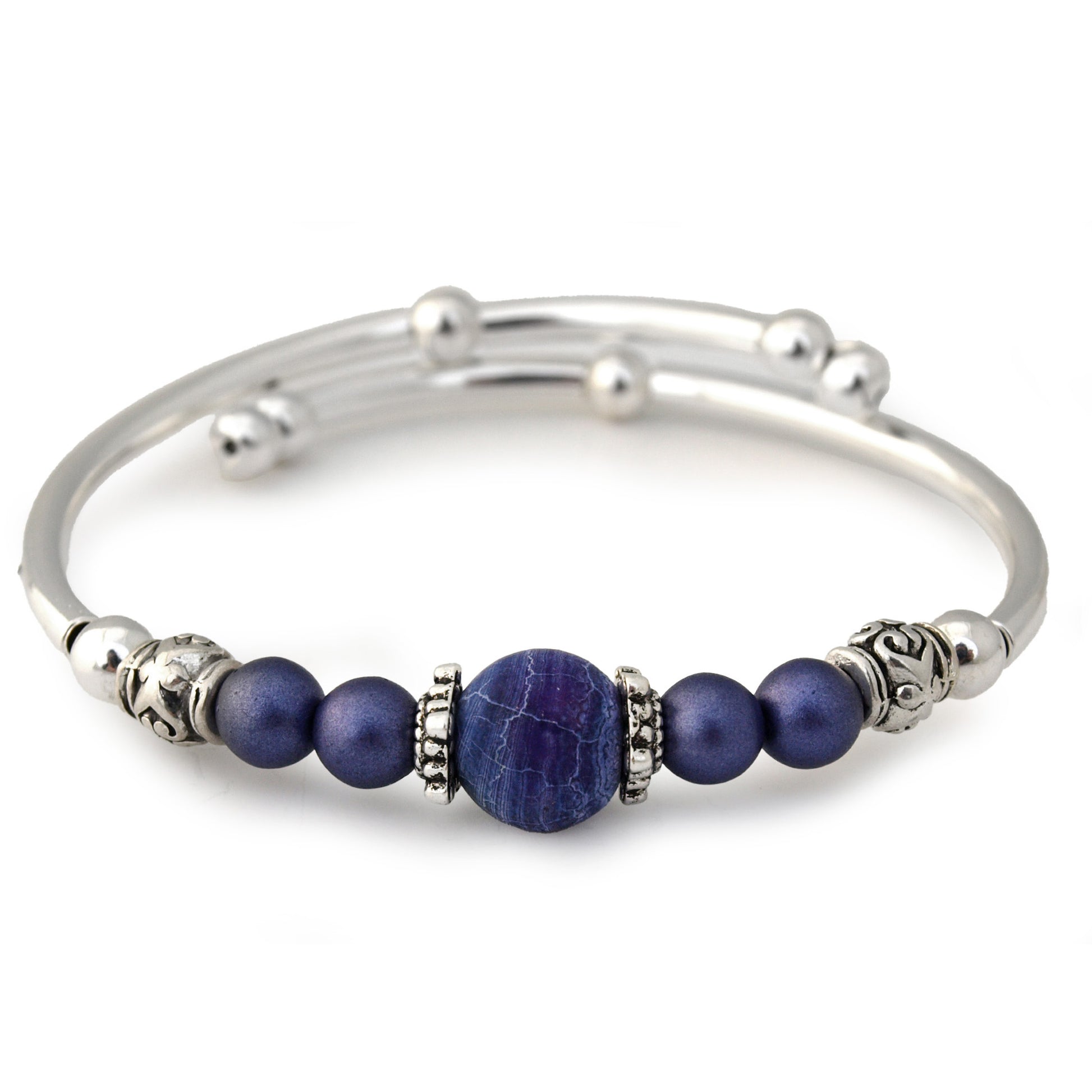 Silver bracelet with purple beads on a white background