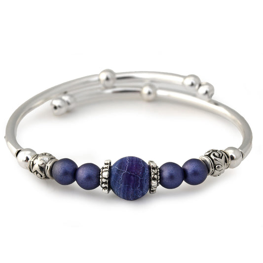 Silver bracelet with purple beads on a white background