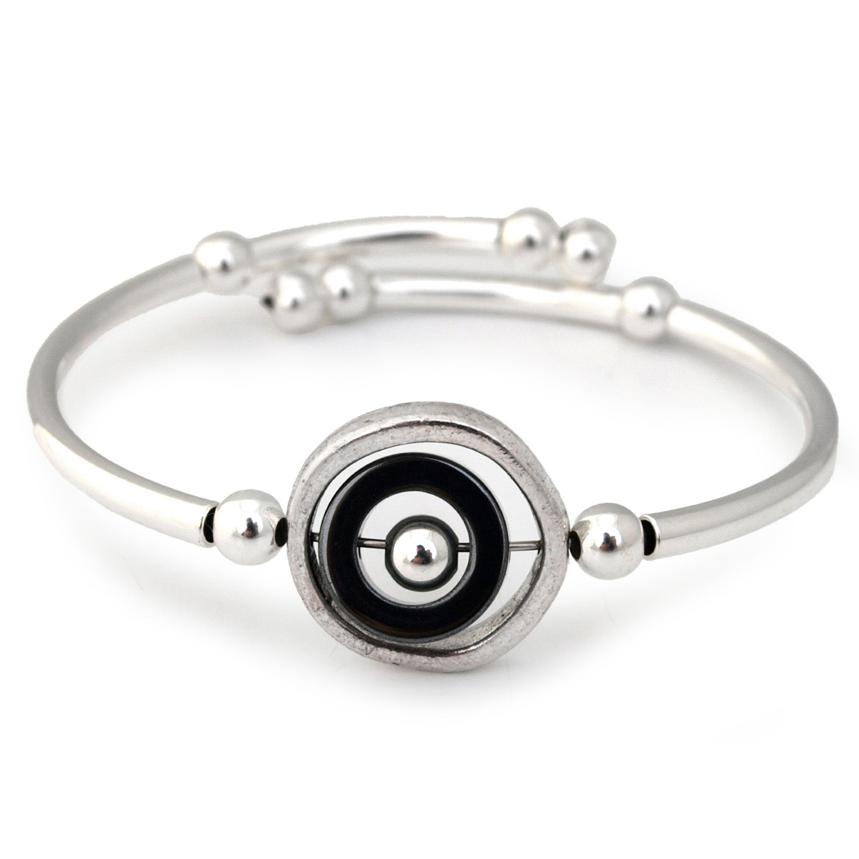 Silver bracelet with a black and silver circular design on a white background