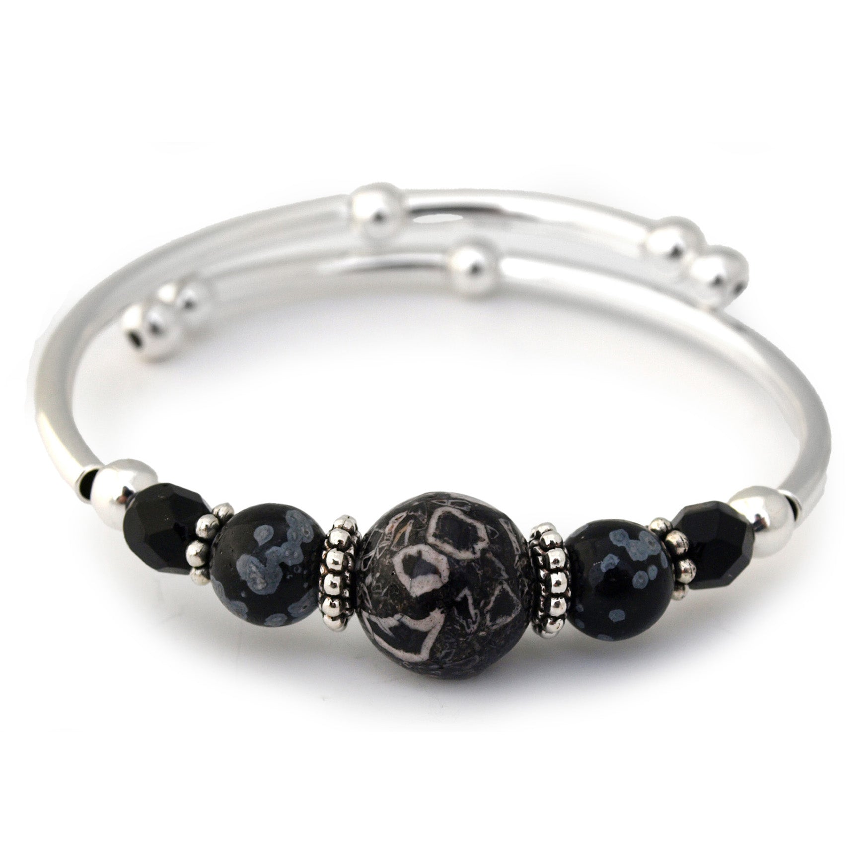 Silver bracelet with black beaded accents on a white background