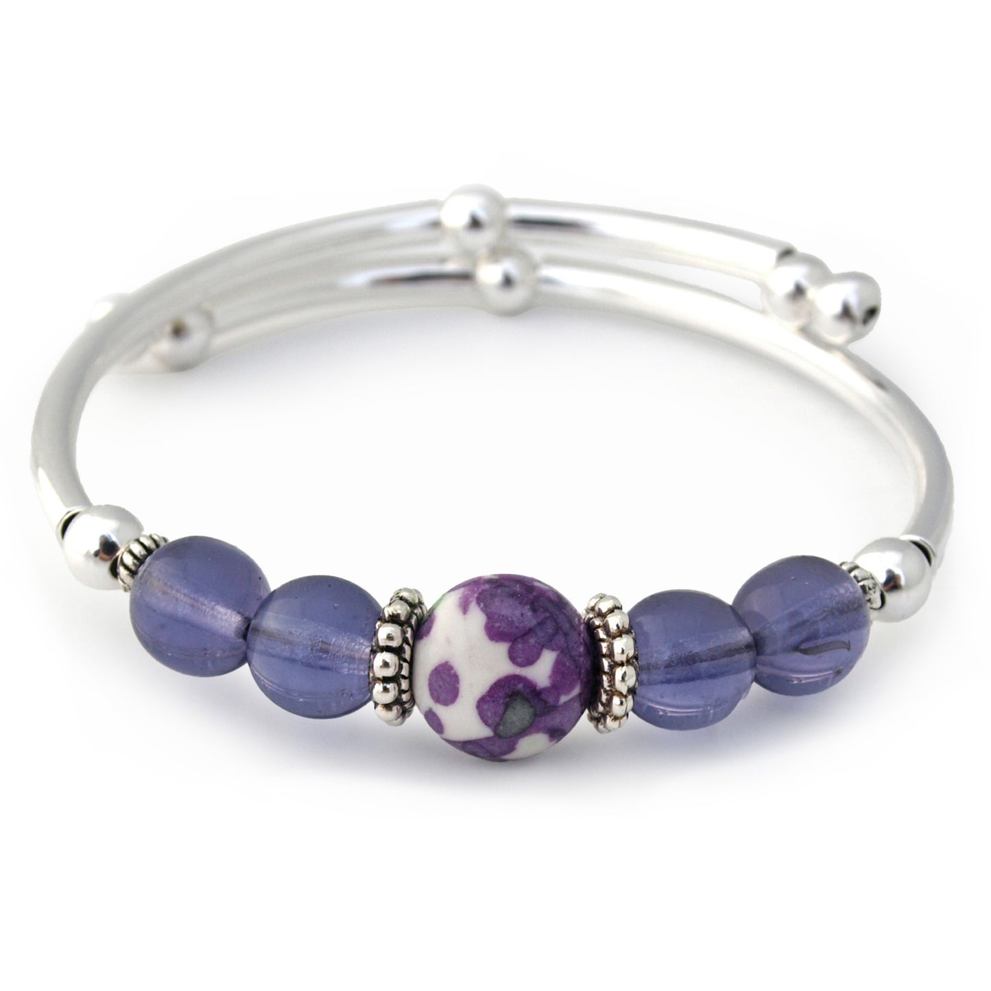 Silver bracelet with purple beads on a white background