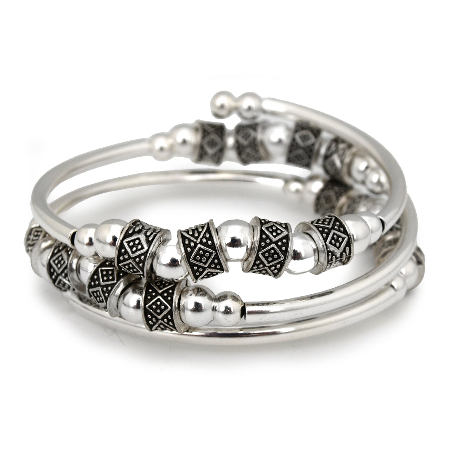 Silver bracelet with intricate designs on a white background